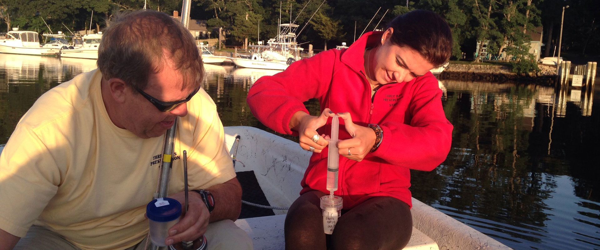 2 people taking Water Monitor Sampling